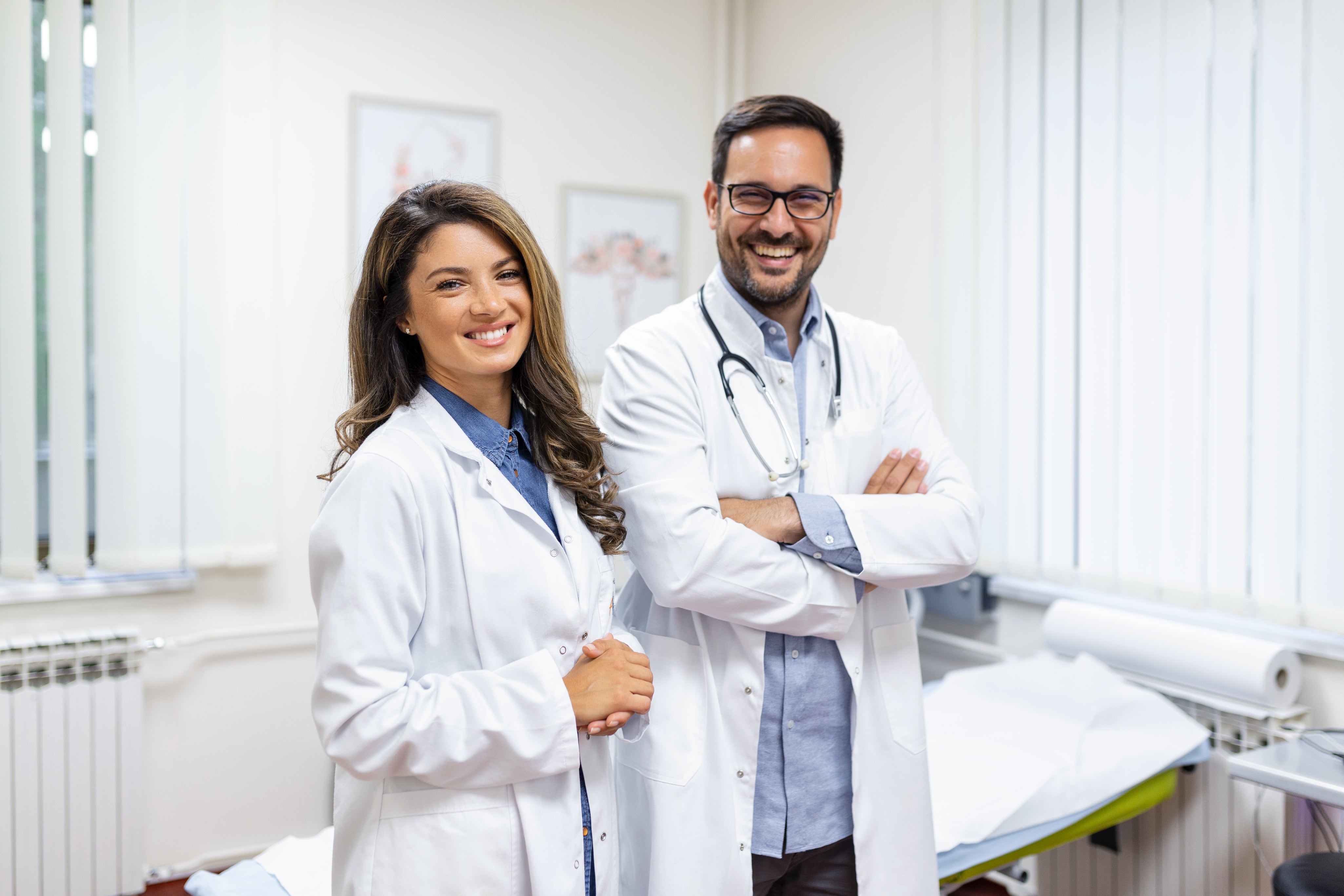 portrait-smiling-young-doctors-standing-together-portrait-medical-staff-inside-modern-hospital-smiling-camera.jpg